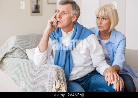 Loving mature woman apologizing to husband after quarrel Stock Photo