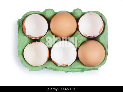 Studio shot of cracked egg shells in an egg box isolated on white - John Gollop Stock Photo
