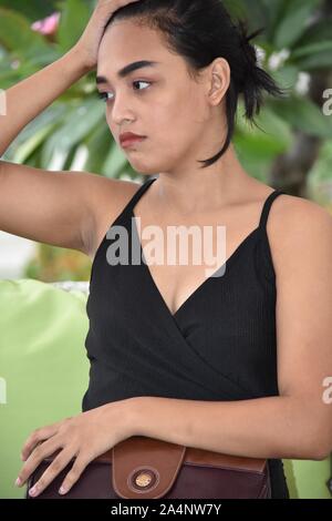 Beautiful Girl And Depression With Purse While Sitting Stock Photo