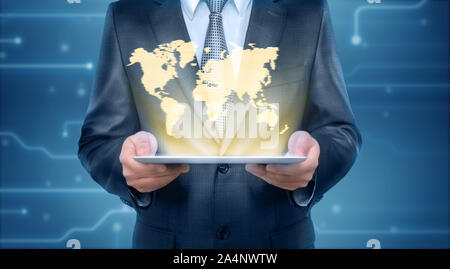 Businessman holding a tablet pc computer with the projection screen of graphic world map. Stock Photo