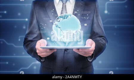 Businessman holding tablet which is showing hologram of the Earth Stock Photo