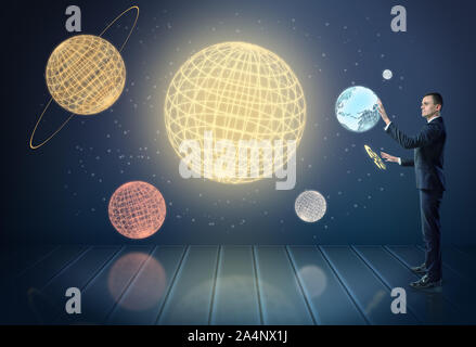 Businessman touching 3d planets of the Solar System, surrounded by stars Stock Photo