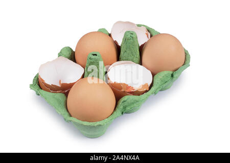 Studio shot of cracked egg shells in an egg box isolated on white - John Gollop Stock Photo