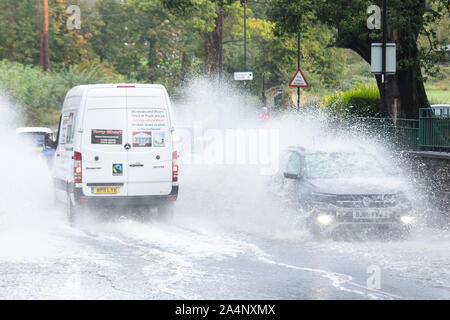 Vehicles make their way through the flooded ford in Castle Street Kenilworth after recent heavy rain and storms Stock Photo