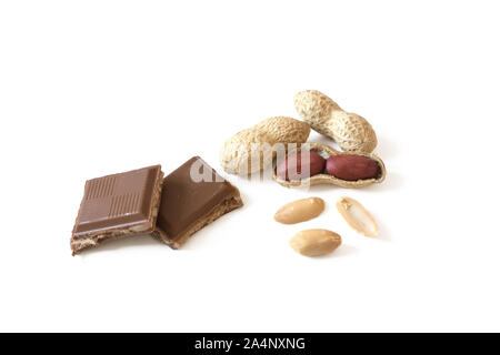 Dried peanut pile and chocolate stuffed with peanut butter isolated on white background. Healthy eating and dieting concept. Stock Photo