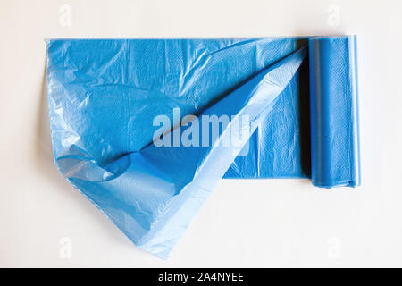 Roll of plastic garbage bag on white background. Waste blue bag for housework. Stock Photo