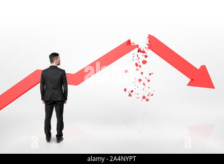 Businessman looking at red broken arrow of falling graph isolated on white background Stock Photo