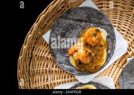 Tacos Gobernador (governors tacos), shrimp tacos cooked with spices and cheese, served on blue corn tortillas with avocado. Stock Photo