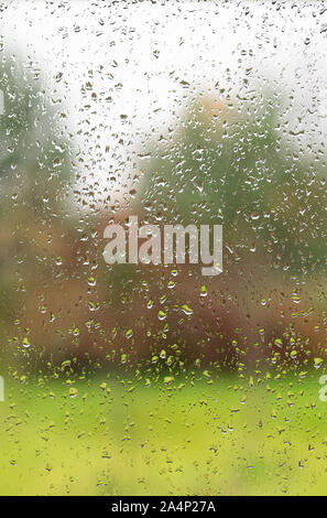 Raindrops on a window pane. View from the window. Autumn weather concept Stock Photo