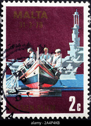 Maltese fisheremen and typical boat on postage stamp Stock Photo