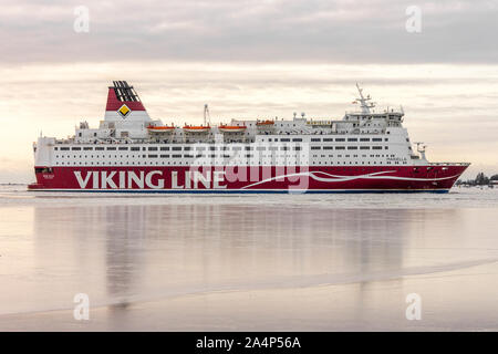 Helsinki, Finland. Viking Line cruise arriving at the port at dawn in winter, with the Fortress of Suomenlinna in the background Stock Photo