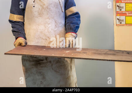 Motswana worker operating a Rolling Machine in a Botswana workshop Stock Photo