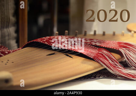 New Year and Christmas celebration concept - number 2020 is written on the background of a stringed folk musical instrument Stock Photo