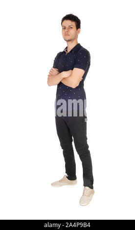A handsome young man in a black sweater and jeans standing with his arms folded, looking into the camera, isolated for white background Stock Photo