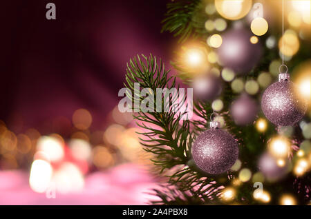 Christmas tree with balls and festive lights on the Christmas background with sparkles Stock Photo