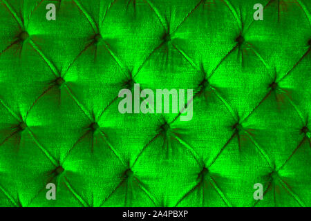 Shiny light green velvet sofa with diamond shape texture with buttons Stock Photo