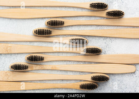 Bamboo toothbrushes on white table Stock Photo