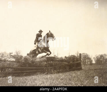 U.S. President Theodore Roosevelt on Horseback Jumping Fence, 1902 Stock Photo