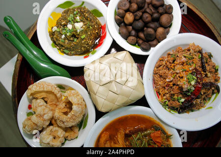 famous northern Thai food, thai green chilli dip or nam prik num pork snack and minced meat spicy salad with sticky rice Stock Photo