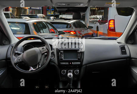 view of a traffic jam in the city at rush hour from the cockpit of a modern car. Stock Photo