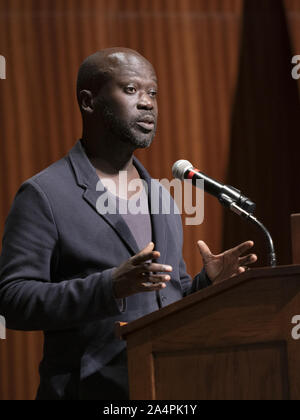 Austin, Texas, USA. 8th Oct, 2019. Noted British architect Sir David Adjaye, a native of Ghana, speaks about his international practice during a lecture at the University of Texas at Austin on October 8, 2019. Adjaye recently was awarded a commission to the build the Abrahamic Family House project in Abu Dhabi. Credit: Bob Daemmrich/ZUMA Wire/Alamy Live News Stock Photo