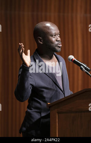 Austin, Texas, USA. 8th Oct, 2019. Noted British architect Sir David Adjaye, a native of Ghana, speaks about his international practice during a lecture at the University of Texas at Austin on October 8, 2019. Adjaye recently was awarded a commission to the build the Abrahamic Family House project in Abu Dhabi. Credit: Bob Daemmrich/ZUMA Wire/Alamy Live News Stock Photo