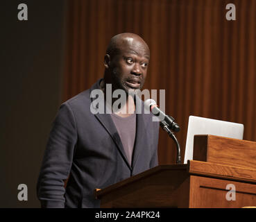 Austin, Texas, USA. 8th Oct, 2019. Noted British architect Sir David Adjaye, a native of Ghana, speaks about his international practice during a lecture at the University of Texas at Austin on October 8, 2019. Adjaye recently was awarded a commission to the build the Abrahamic Family House project in Abu Dhabi. Credit: Bob Daemmrich/ZUMA Wire/Alamy Live News Stock Photo