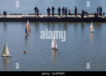 Enthusiasts racing their radio controlled sailing boats on the Steveston waterfront in British Columbia Canada Stock Photo