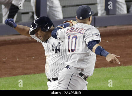 Bronx, United States. 15th Oct, 2019. Houston Astros Yuli Gurriel tags out New York Yankees Edwin Edwin Encarnacion at first base in the 8th inning in game 3 of the American League Championship Series at Yankee Stadium on Tuesday, October 15, 2019 in New York City. The Yankees and the Astros are tied in the best of 7 series 1-1. Photo by John Angelillo/UPI Credit: UPI/Alamy Live News Stock Photo