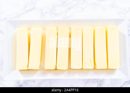 Organic sticks of butter at the room temperature. Stock Photo