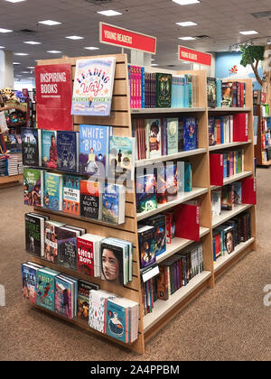 Rows of different colorful books lying on the shelves in the modern urban bookshop, San Diego, USA, Ocotber 09, 2019 Stock Photo