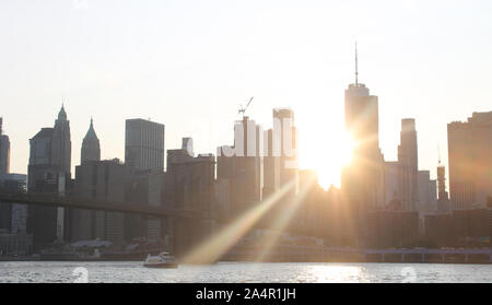 New York City skyline at dusk with sun burst Stock Photo