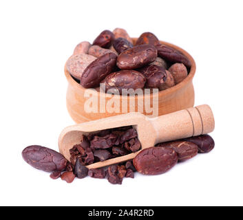 Peeled cocoa beans in the wooden bowl, isolated on white background. Roasted and aromatic cocoa beans in wooden spoon, natural chocolate. Stock Photo