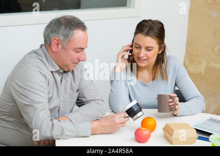 colleagues having lunch in the office Stock Photo