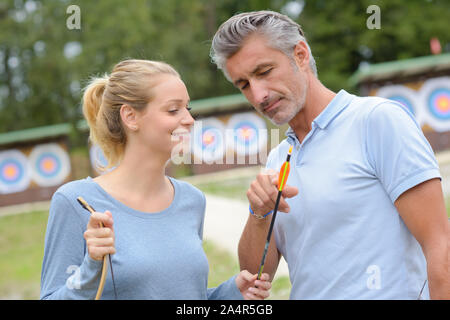 portrait of couple practicing archery Stock Photo