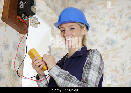 portrait of female electrician using multimeter Stock Photo