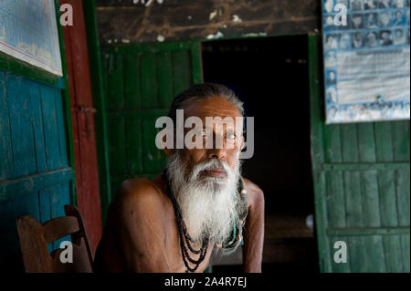 Modelrelease no: 023.Laxman Chandra Mandal, 76, an elderly man posed for photographs while he is taking rest at home adjacent to Sundarbans mangrove on March 10, 2009, in Village- Mathbaia, Kayra, Khulna, Bangladesh. Stock Photo