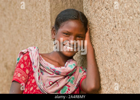 A young girl from the ethnic Santal community in Joypurhat, Rajshahi, Bangladesh. May 20, 2011..The Santals are an ethnic minority community living in different districts of Rajshahi division in Bangladesh. Most do not own land and work as daily paid labourers for very low wages. Much of the advancements in technology have bypassed these isolated communities where males dominate and women shoulder the burden of farming and carrying out other livelihoods..Santals are also the largest ethnic group in India where they have settlements in the states of Jharkhand, West Bengal, Bihar, Orissa, and As Stock Photo