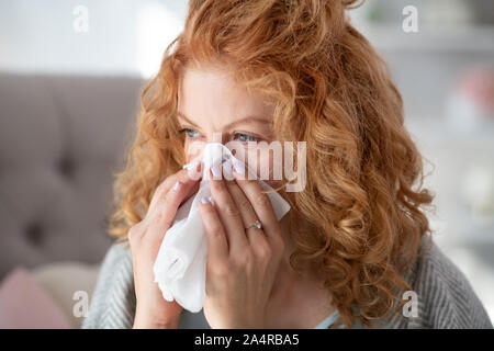 Young woman spending all day long while having running nose Stock Photo
