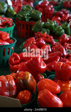 Biologic, natural cultivated red sweet pepper on a market counter. Vegetables from the farmers market. Ecologic products. Natural background. Stock Photo