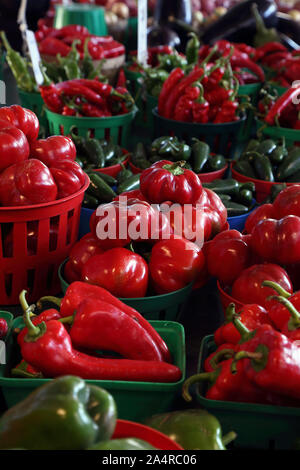 Biologic, natural cultivated sweet and hot pepper on a market counter. Vegetables from the farmers market. Ecologic products. Natural background. Stock Photo