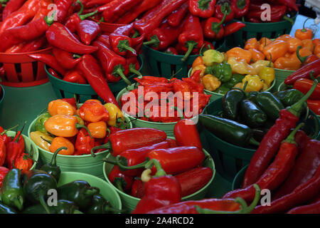 Biologic, natural cultivated hot pepper on a market counter. Vegetables from the farmers market. Ecologic products. Natural background. Stock Photo