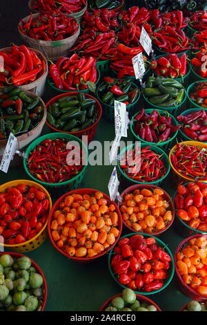 Biologic, natural cultivated hot pepper on a market counter. Vegetables from the farmers market. Ecologic products. Natural background. Stock Photo