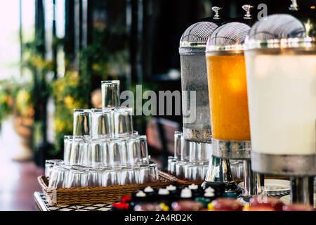 Drinking water, orange juice and milk dispenser for guests at the hotel Stock Photo