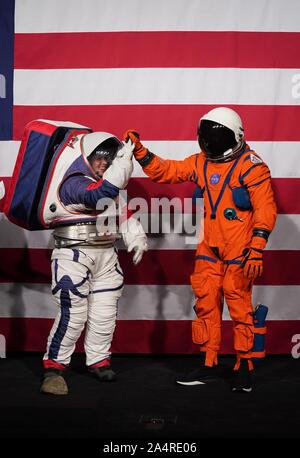 Beijing, USA. 15th Oct, 2019. Advanced Space Suit Engineer Kristine Davis (L) and lead engineer Dustin Gohmert display two spacesuits designed for lunar exploration at NASA headquarters in Washington, DC, the United States, on Oct. 15, 2019. The U.S. space agency NASA unveiled on Tuesday the next-generation spacesuits to be used in its Artemis program that will send the first woman and next man to the Lunar South Pole by 2024. Credit: Liu Jie/Xinhua/Alamy Live News Stock Photo