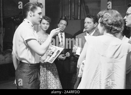 Elvis Presley backstage with fans at the University of Dayton Fieldhouse, May 27, 1956.