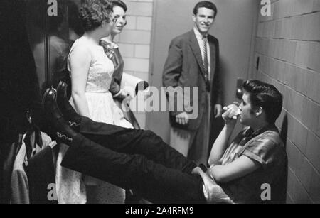 Elvis Presley, talking with fans backstage at the University of Dayton Fieldhouse, May 27, 1956.