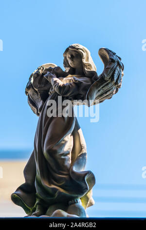 Statue of an angel playing harp in the garden Stock Photo