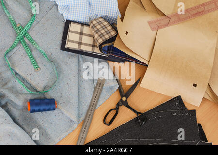 High angle view of fabric and patterns and different useful things for sewing are on the table Stock Photo