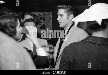 Elvis Presley speaking with fans at an adult party after his show at the Fox Theater, Detroit, Michigan, May 25, 1956. Stock Photo